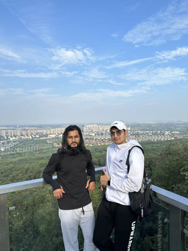 PrimeLink team members at a hilltop viewpoint in China